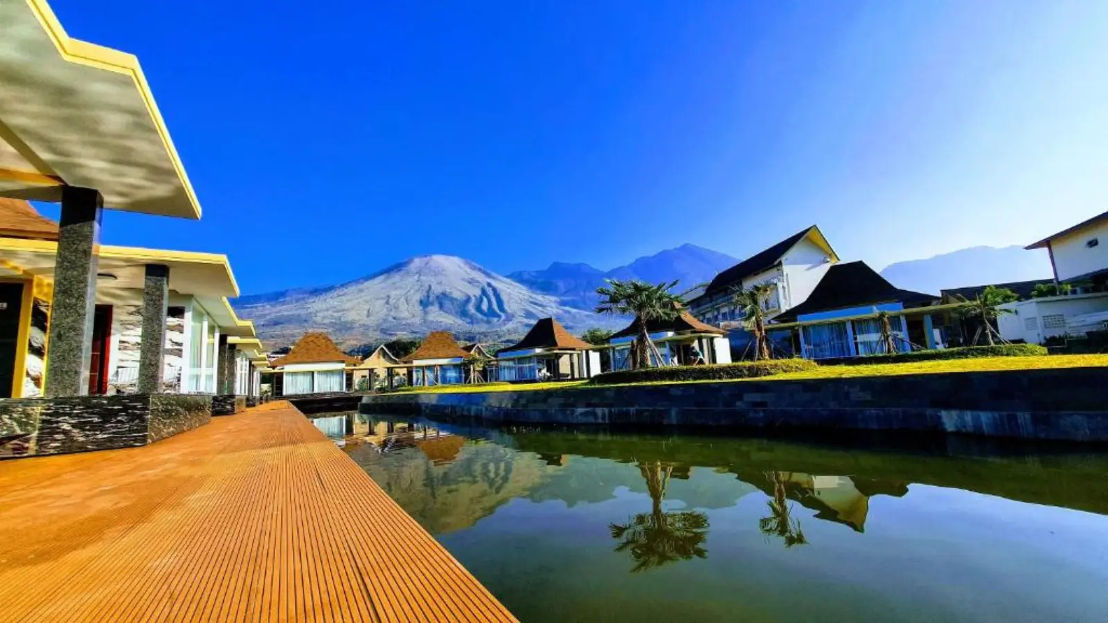 Cahaya Villa Garut villas along the reflecting pond with Mount Guntur in the background