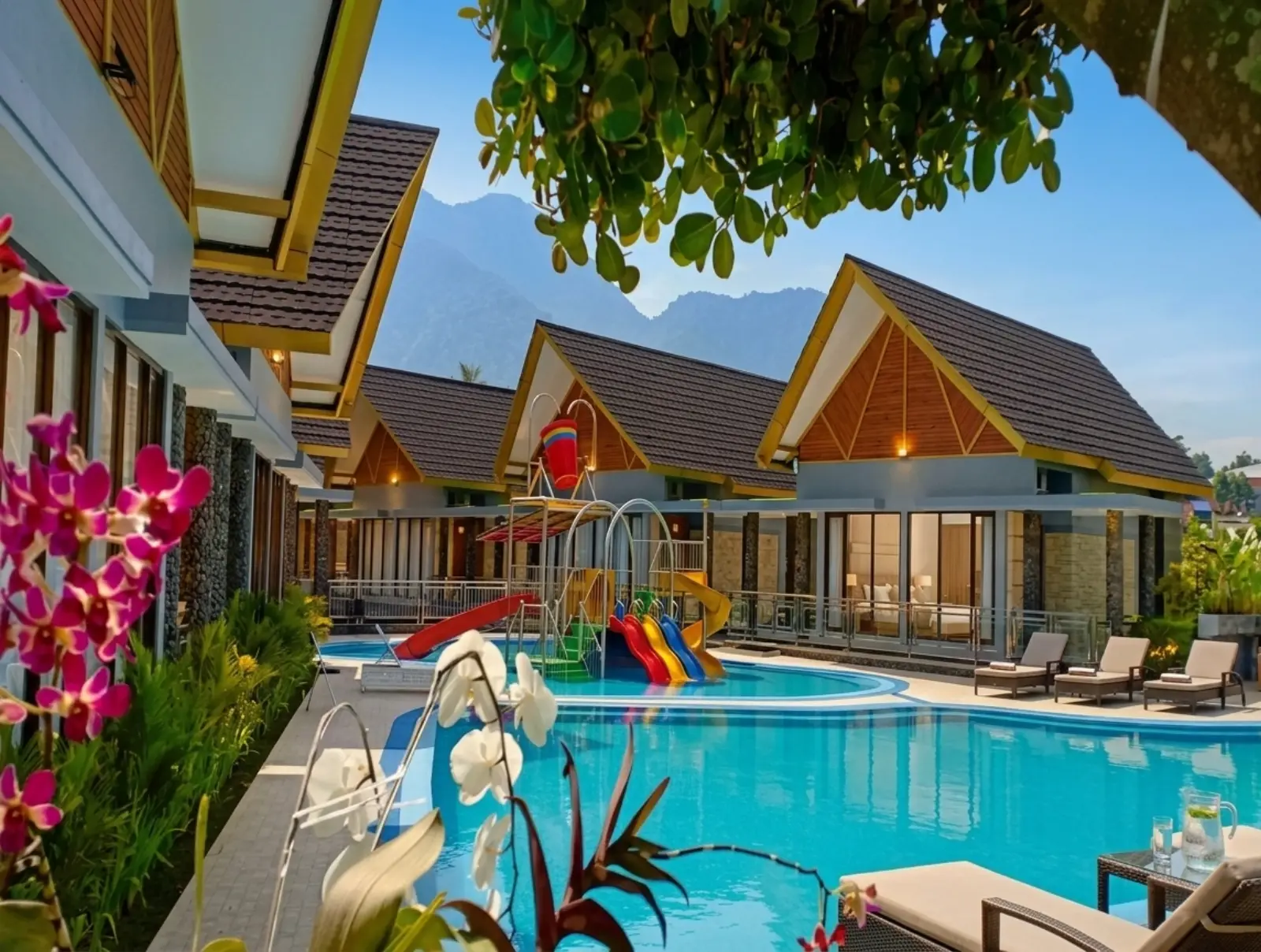 Two outdoor pools at Cahaya Villa Garut with Mount Guntur in the background